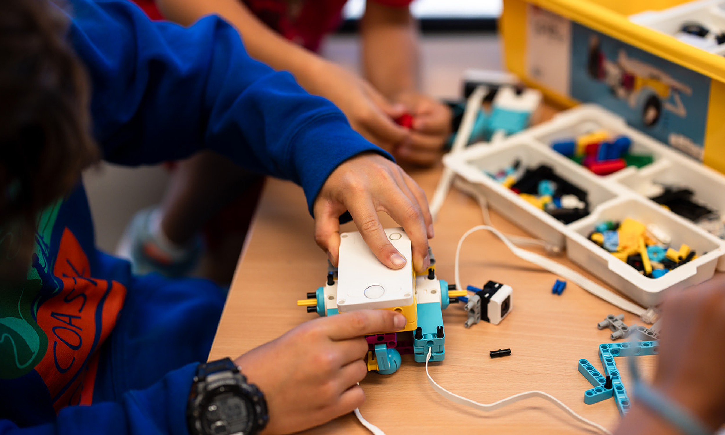 Child building a LEGO at Hanna Center Camps.