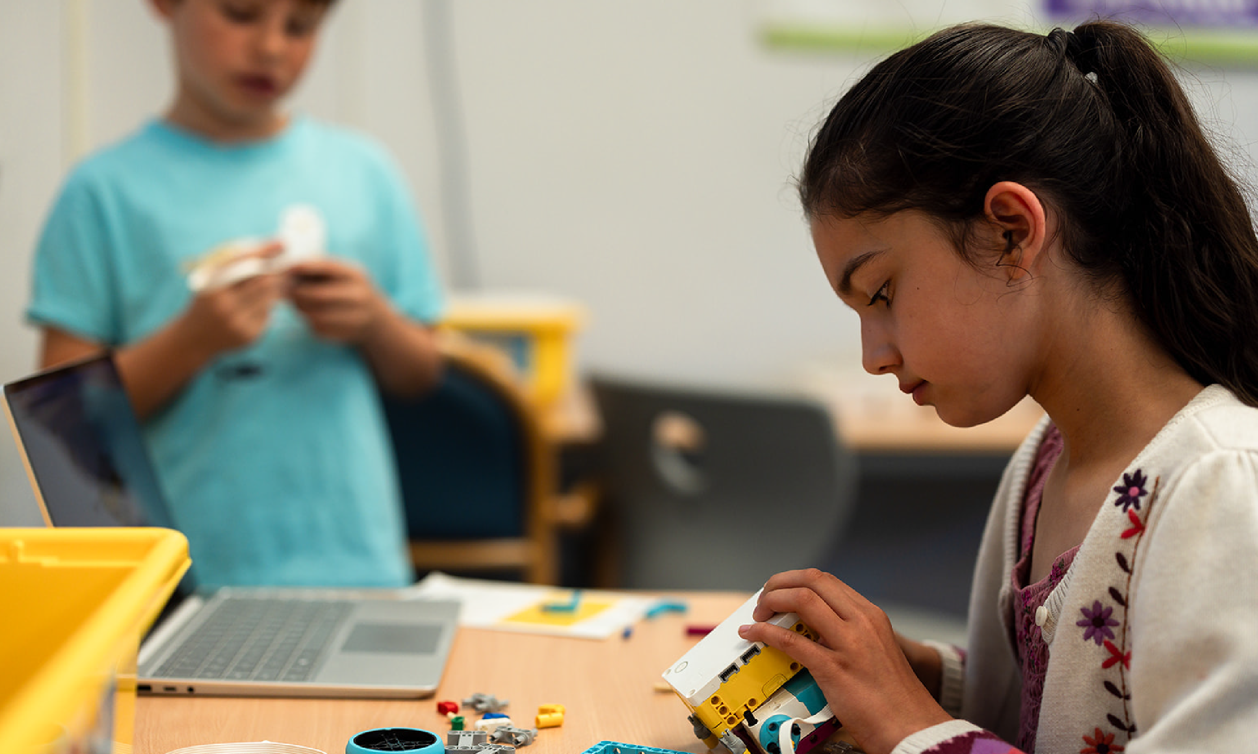Child building a LEGO at Hanna Center Camps.