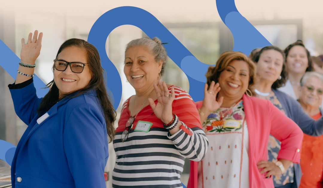 Group of people waving with Hanna Center map pathway graphic in the background.