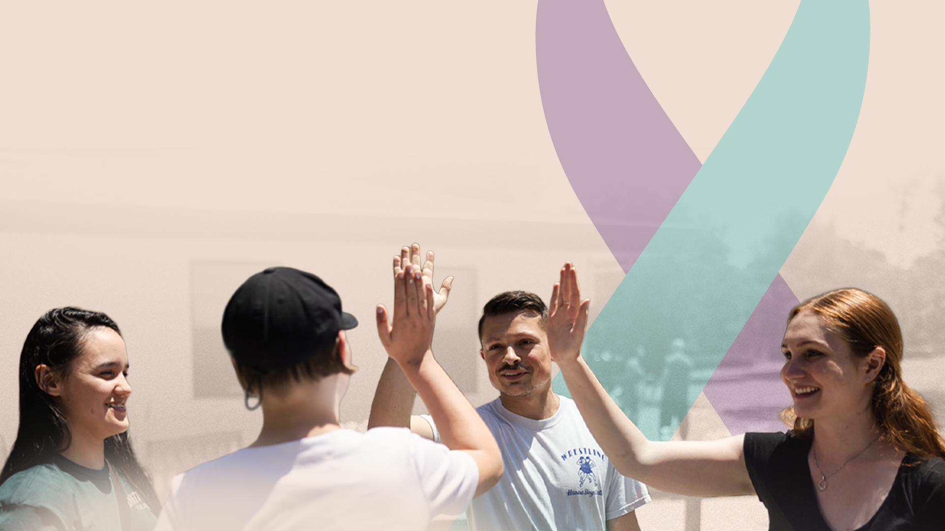 People exchanging high-fives beside a teal and purple suicide prevention awareness ribbon.